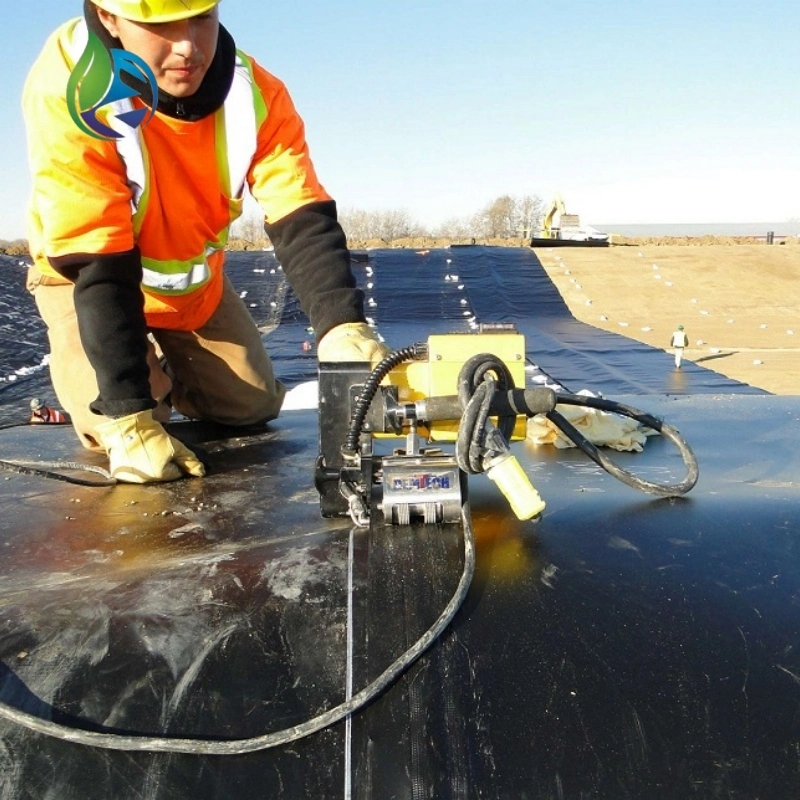 Technician performing hot wedge welding on HDPE landfill liner seams